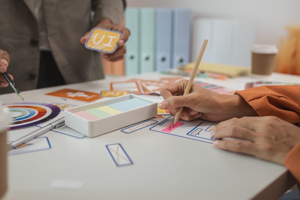 Thoughtful design — team collaborating on wireframes and UX sketches